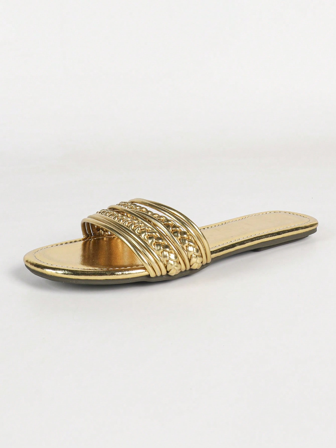 Women's gold flat sandals with metal accent detail, strappy lace-up design, and toe post thong style.