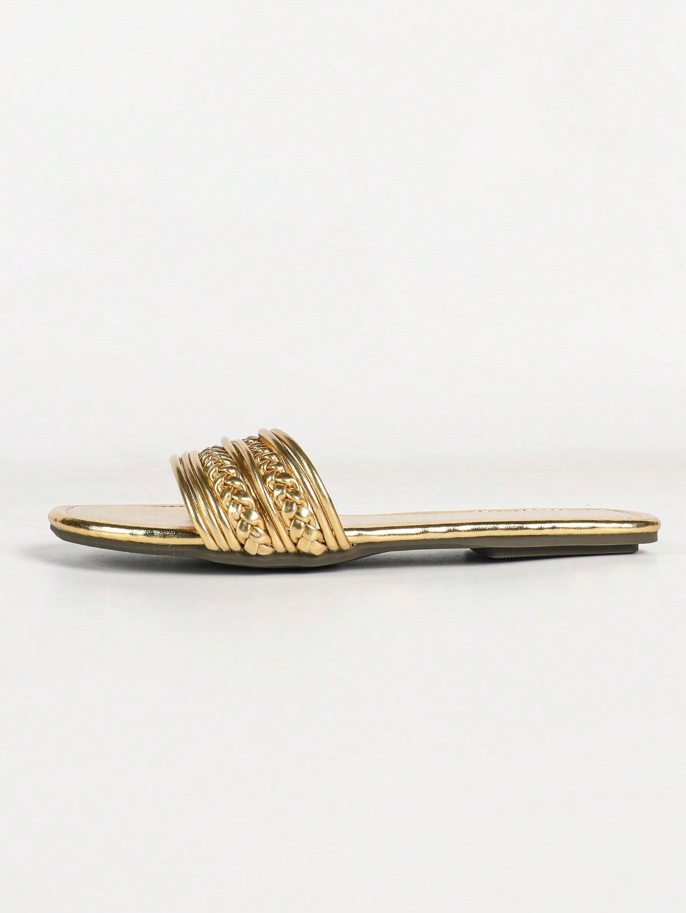 Women's gold flat sandals with metal accent detail, strappy lace-up design, and toe post thong style.
