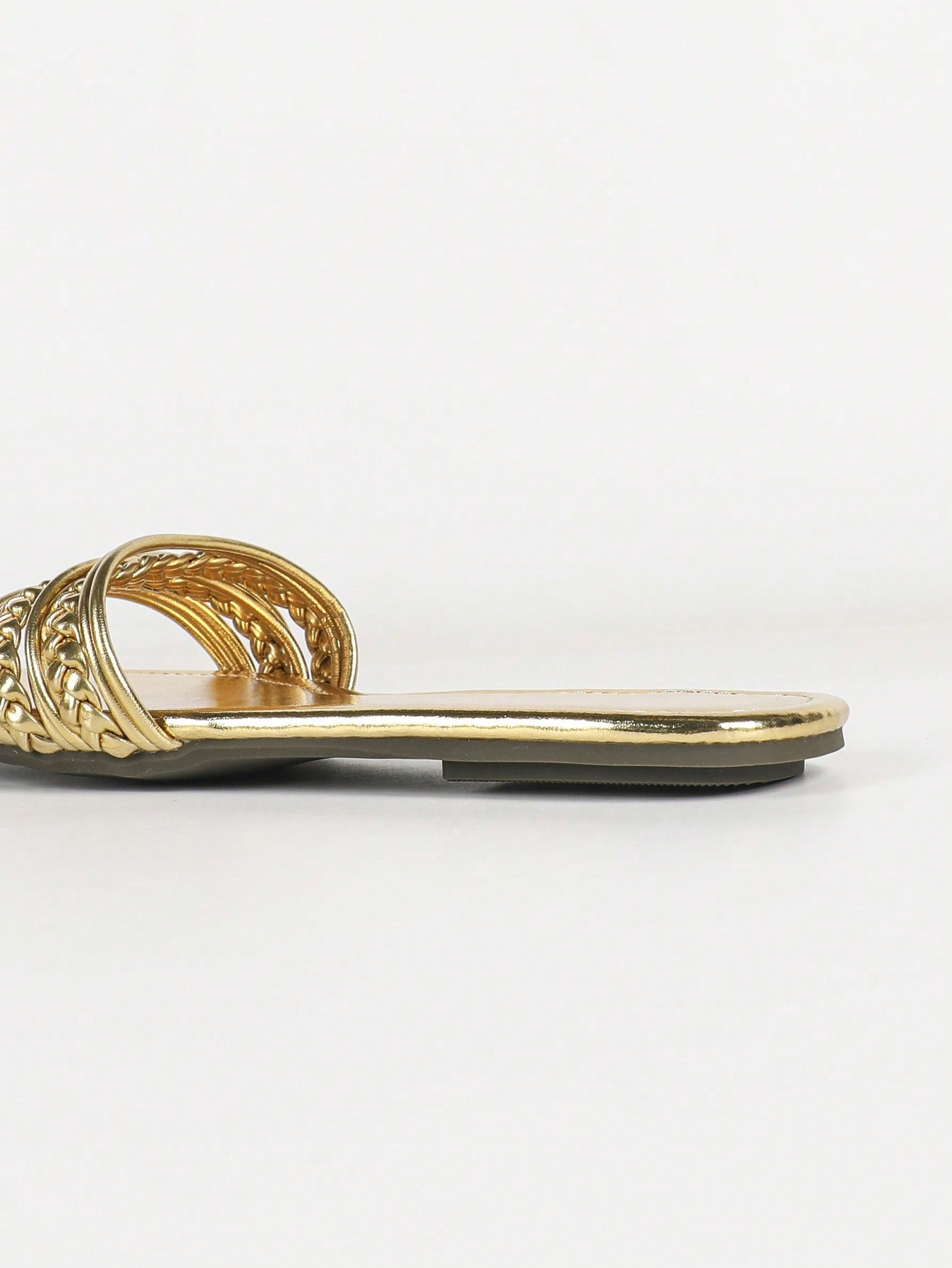Women's gold flat sandals with metal accent detail, strappy lace-up design, and toe post thong style.