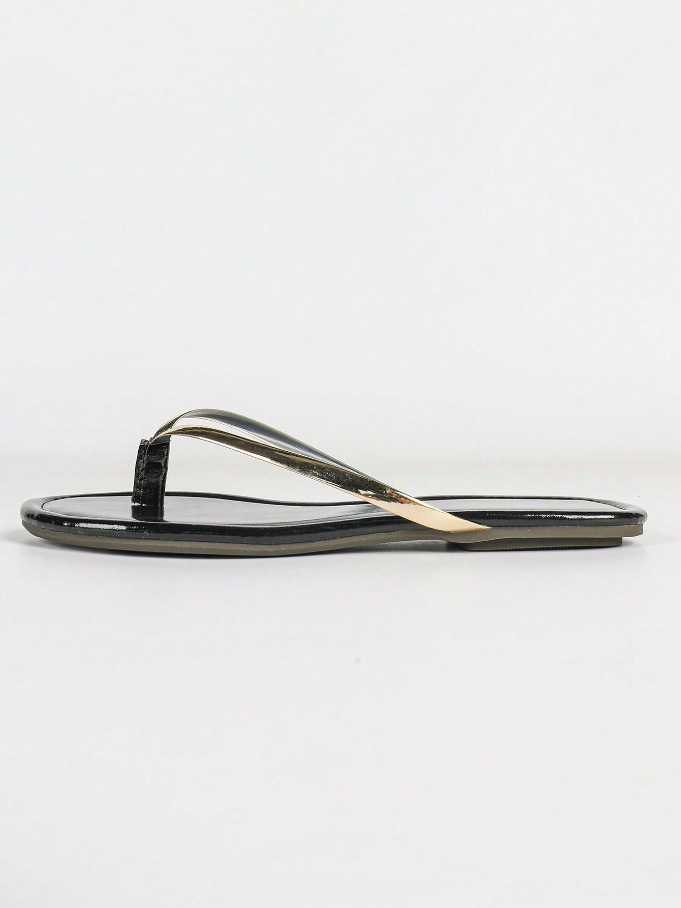 Women's gold flat sandals with metal accent detail, strappy lace-up design, and toe post thong style.