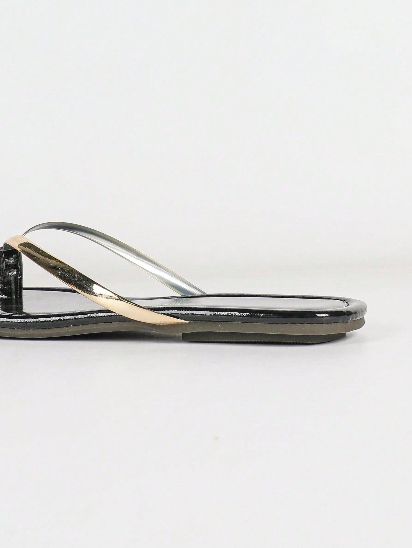 Women's gold flat sandals with metal accent detail, strappy lace-up design, and toe post thong style.