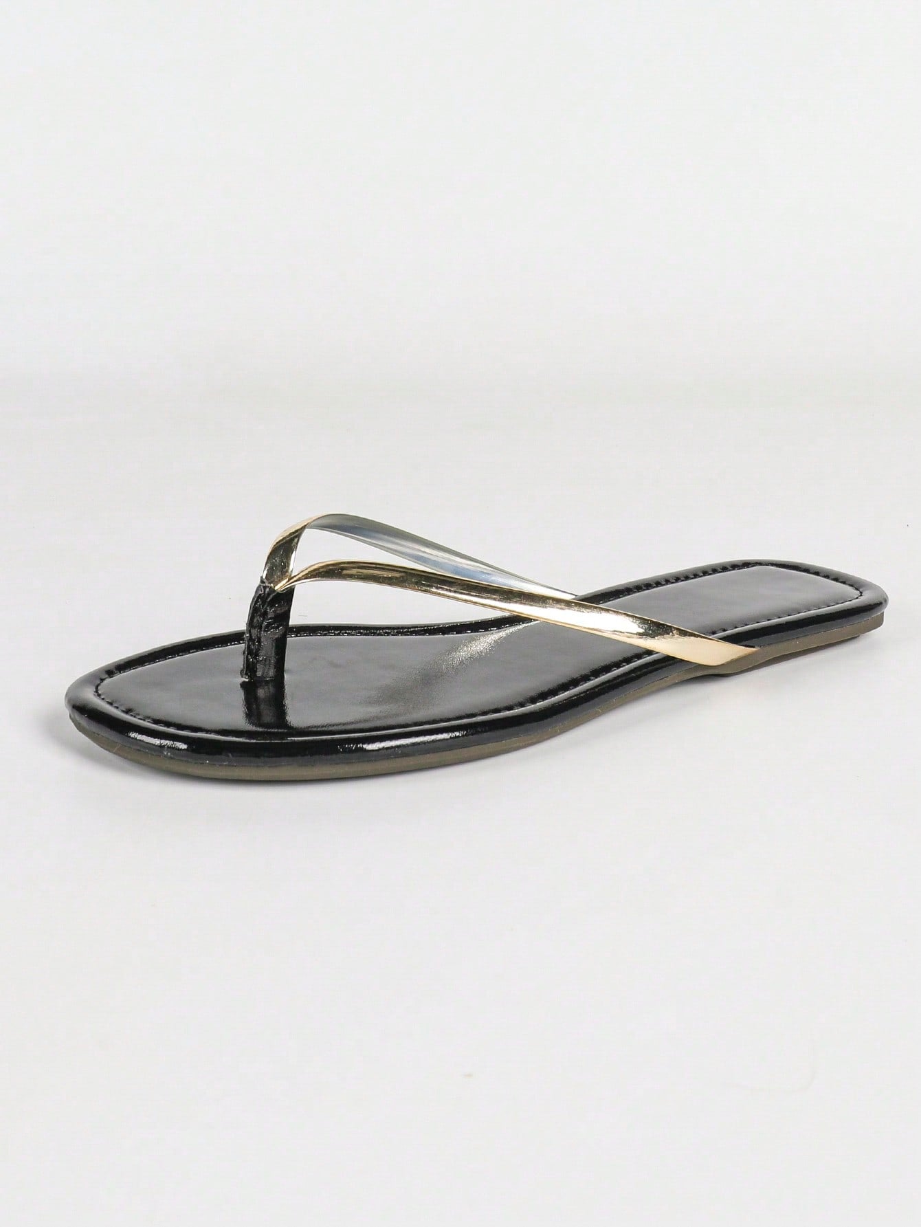 Women's gold flat sandals with metal accent detail, strappy lace-up design, and toe post thong style.