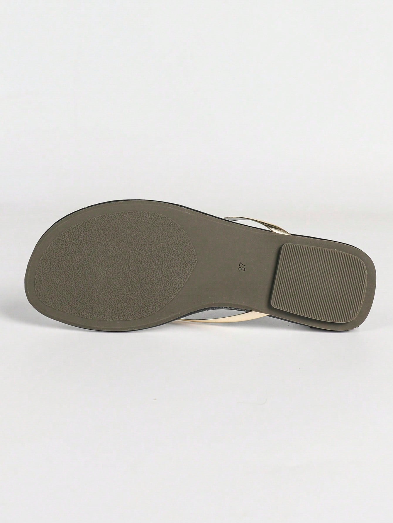 Women's gold flat sandals with metal accent detail, strappy lace-up design, and toe post thong style.