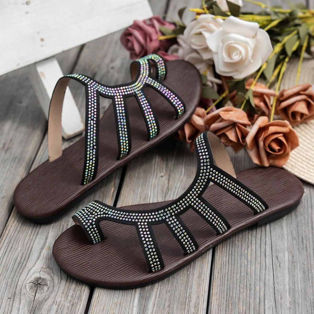 Women's flat sandals with strappy rope-detail design, plant pattern, and open-toe silhouette.