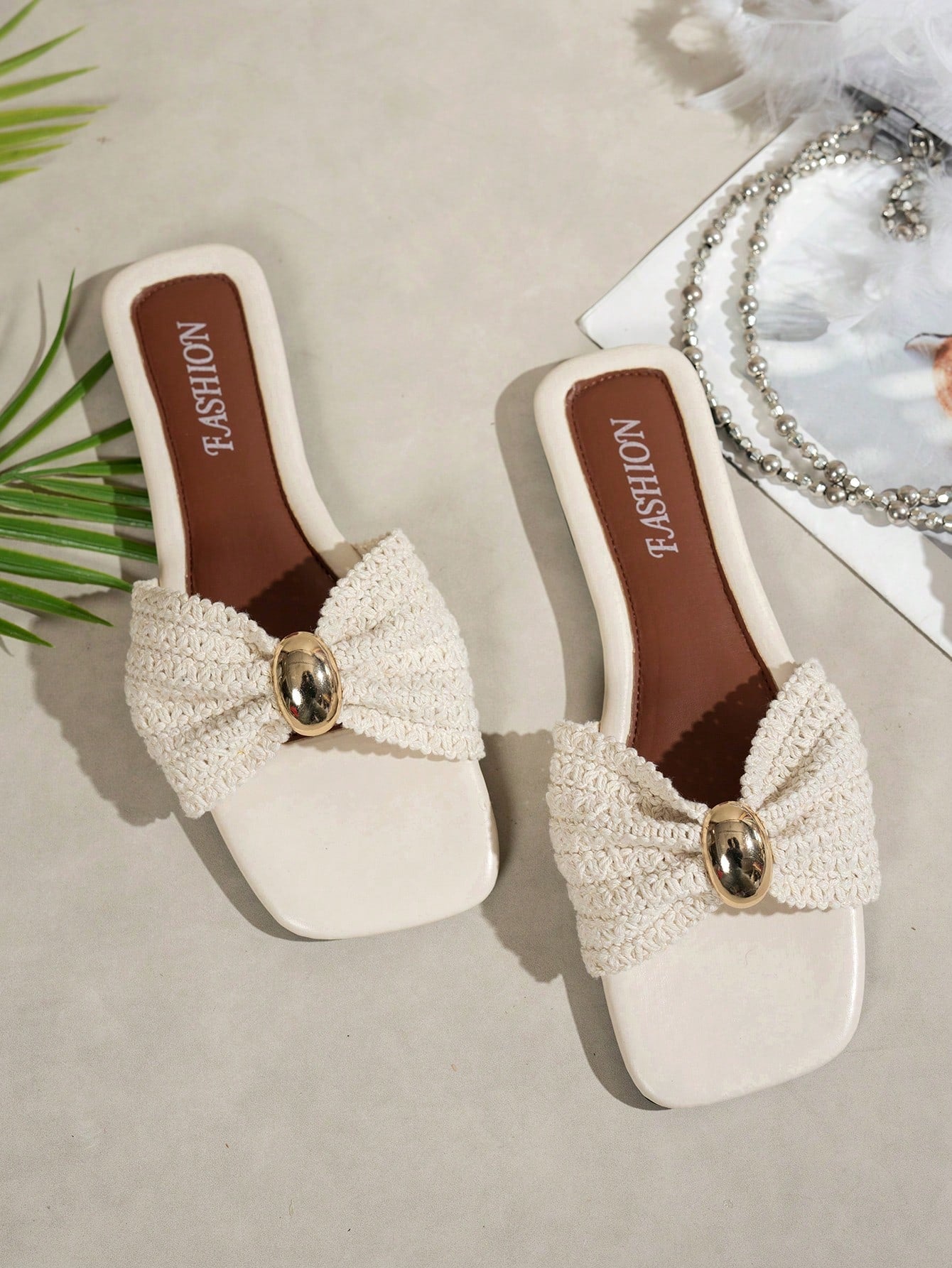 Women's ginger woven flat slide sandals with open toe, bow knot detail, and metal decor in a minimalist beach style.