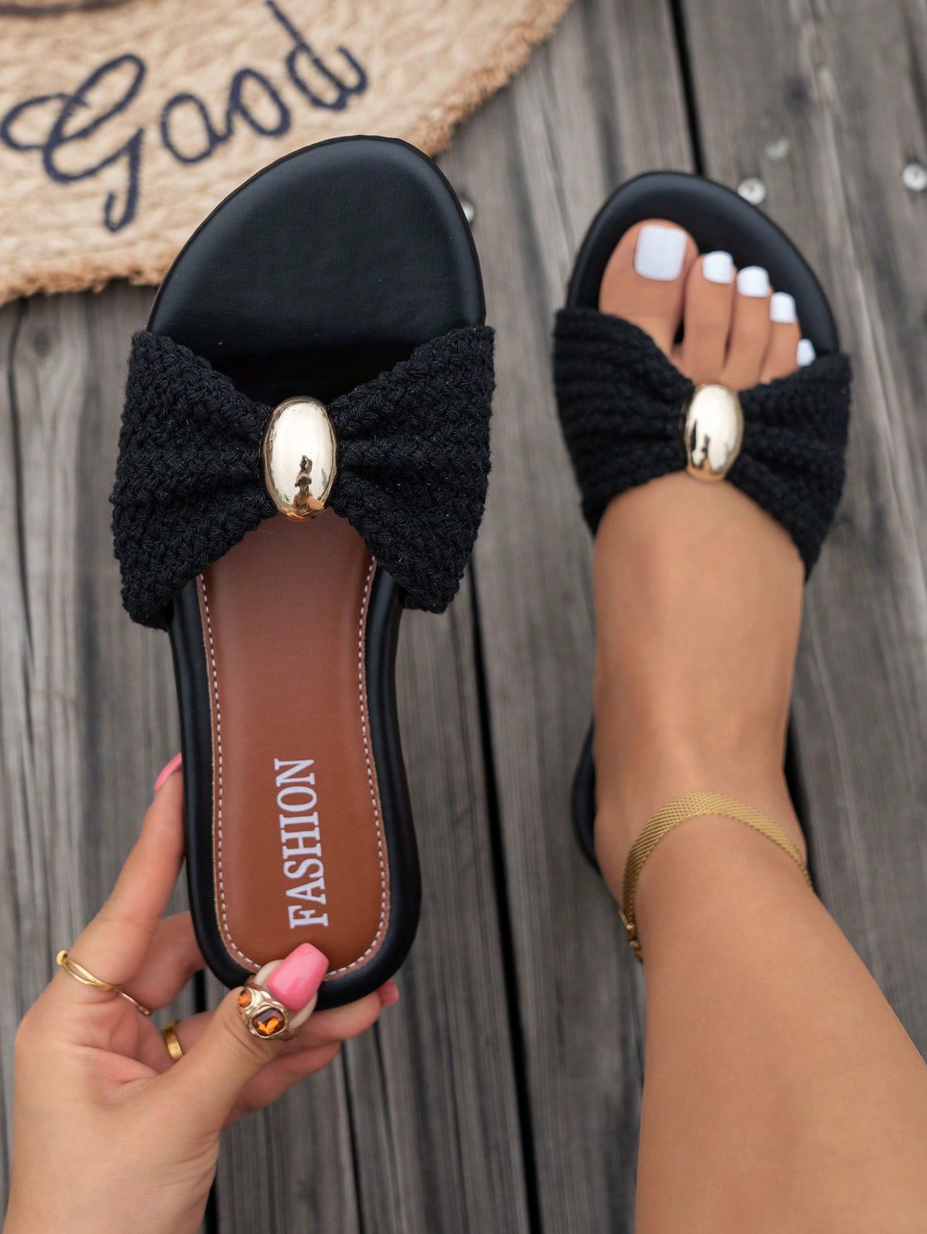 Women's brown straw woven flat slide sandals with bowknot metal decor, braided open-toe strap, and round toe.