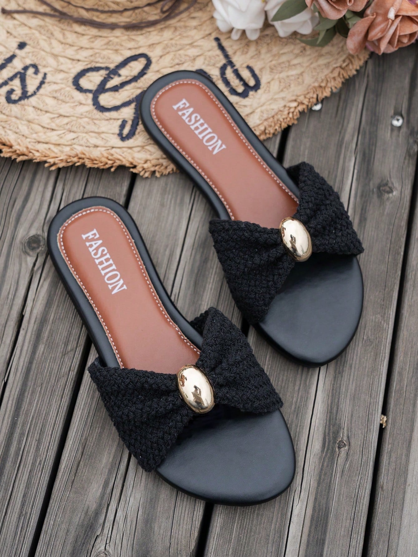 Women's brown straw woven flat slide sandals with bowknot metal decor, braided open-toe strap, and round toe.