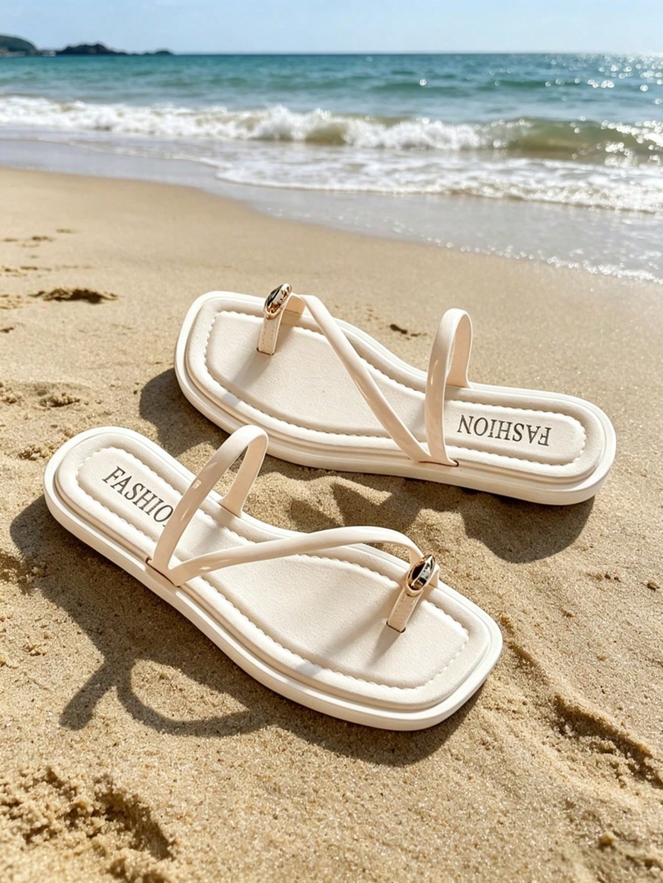 Women's white flat slide sandals featuring criss cross straps, shell detail, and buckle accents