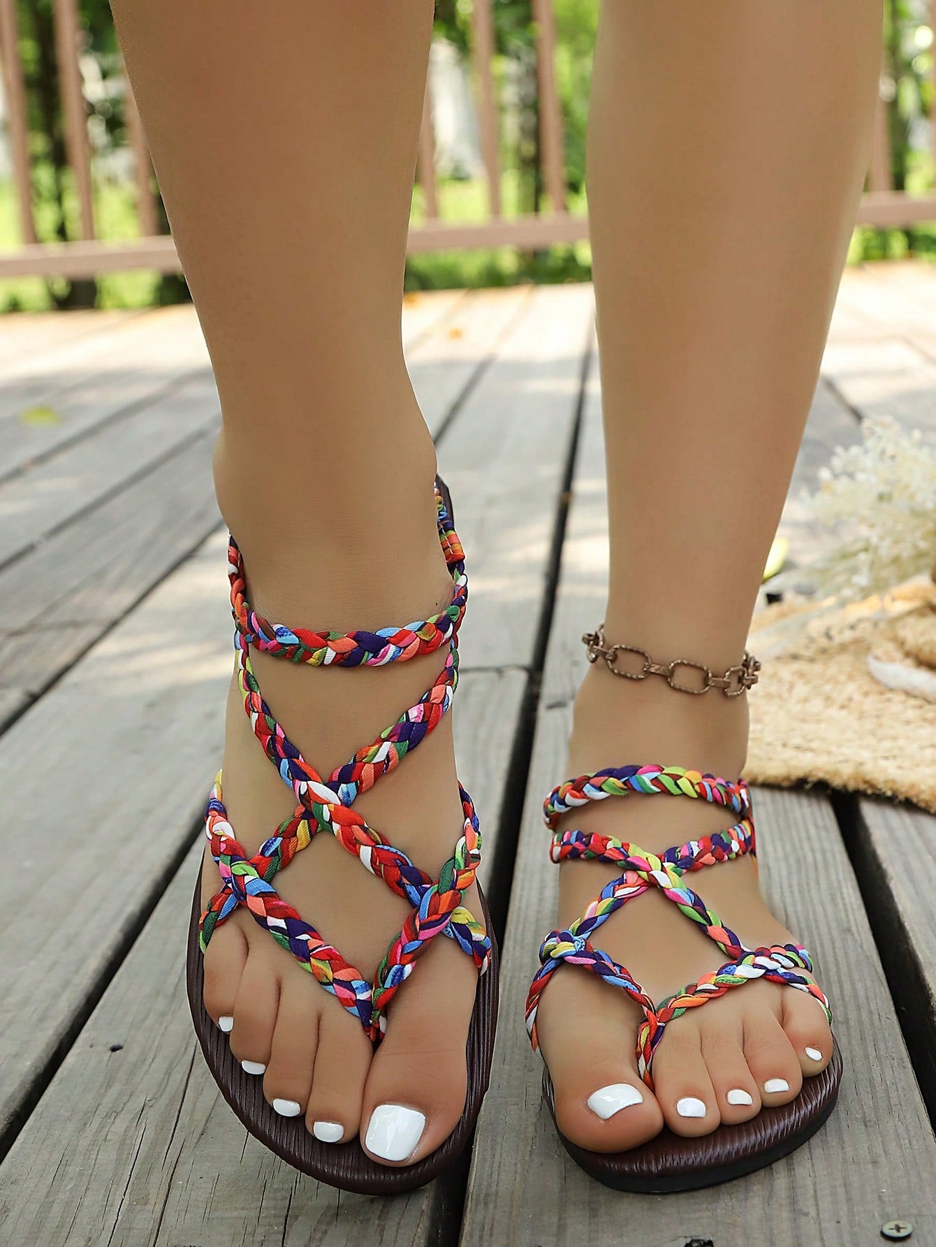 Open-toe flat slide sandals featuring rhinestone leaf decoration in a vacation-inspired style.