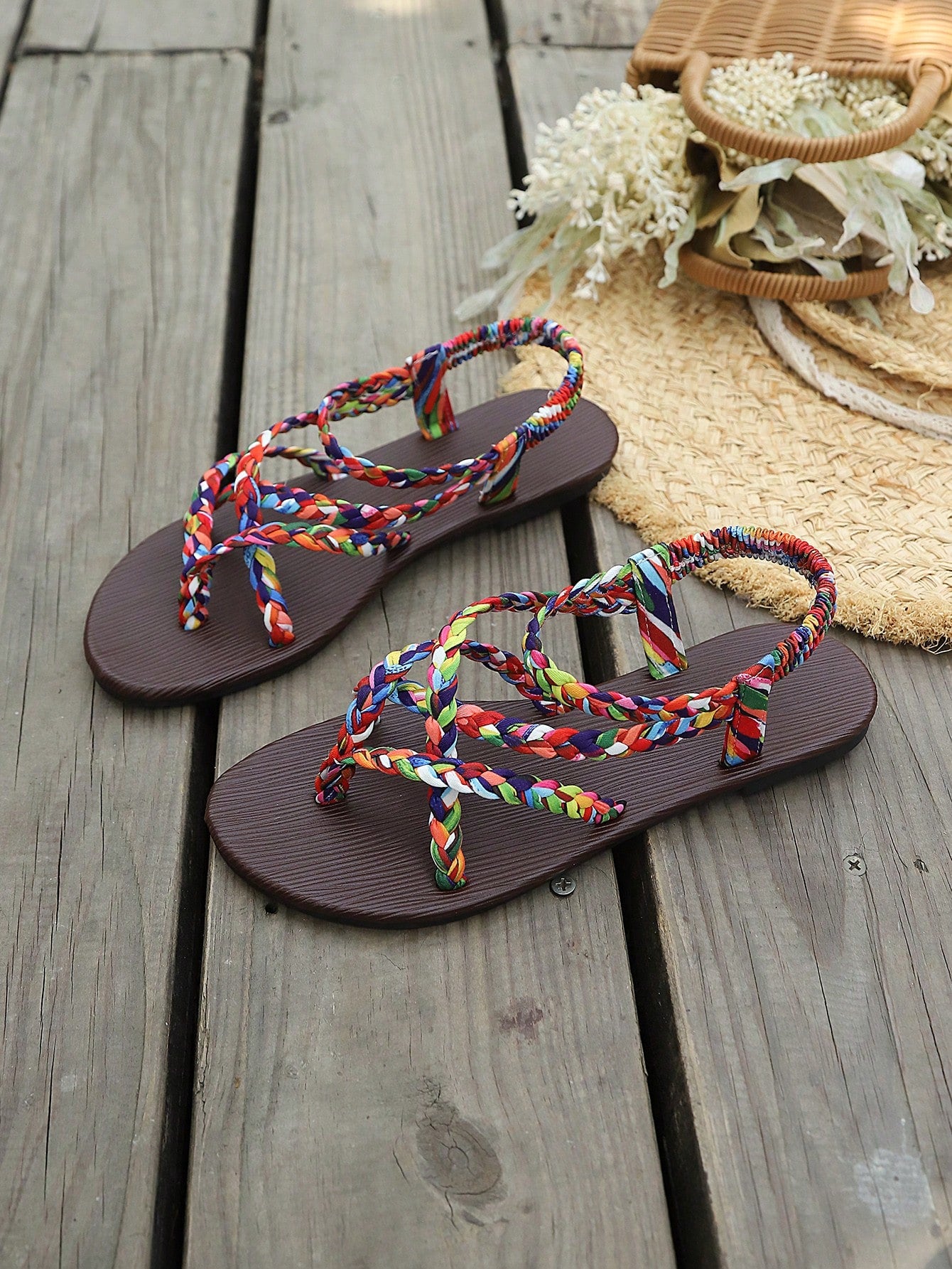 Open-toe flat slide sandals featuring rhinestone leaf decoration in a vacation-inspired style.