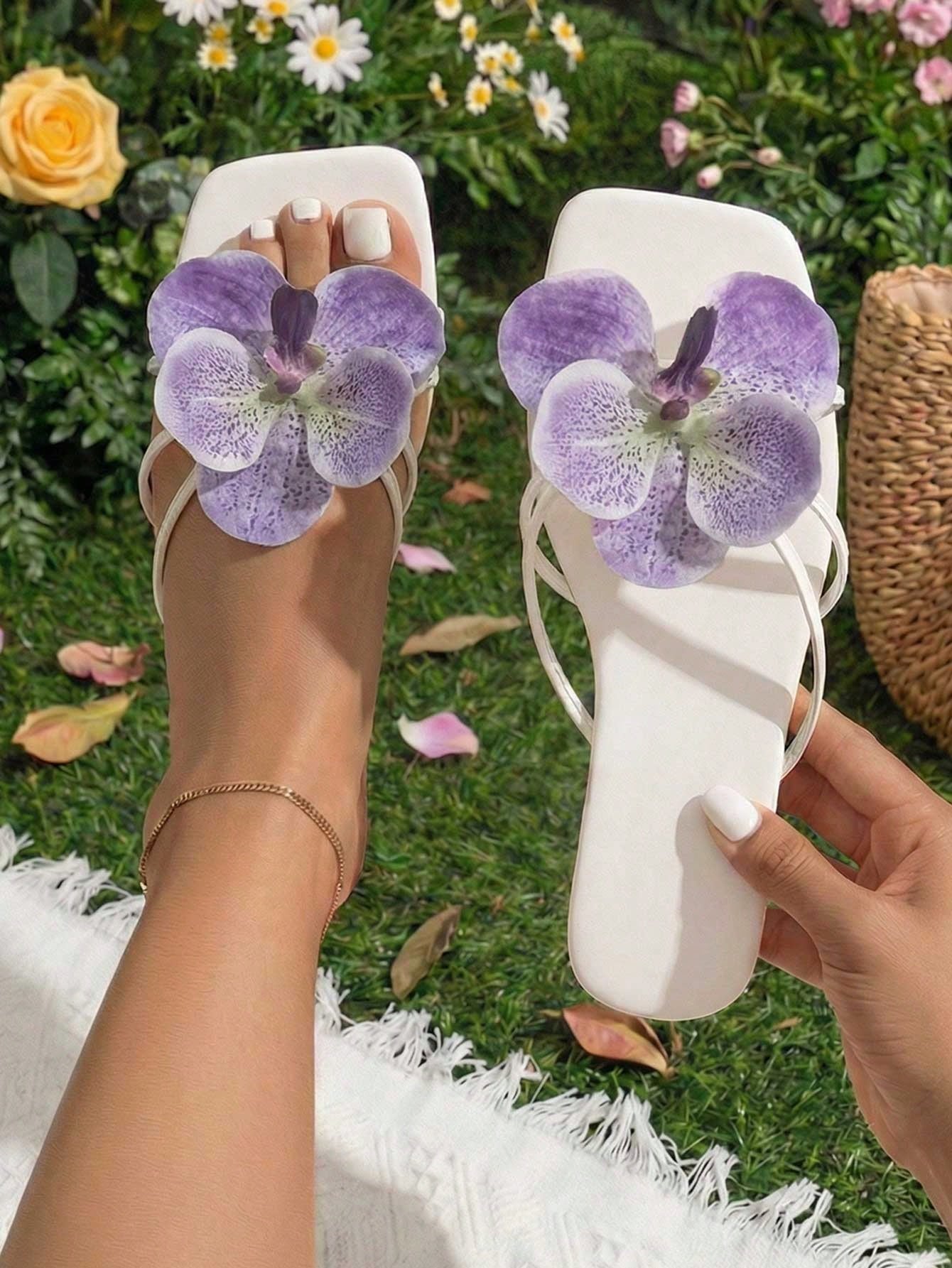 Women's black flat slide sandals with toe post design, textured PU leather straps, and rhinestone heart decoration.