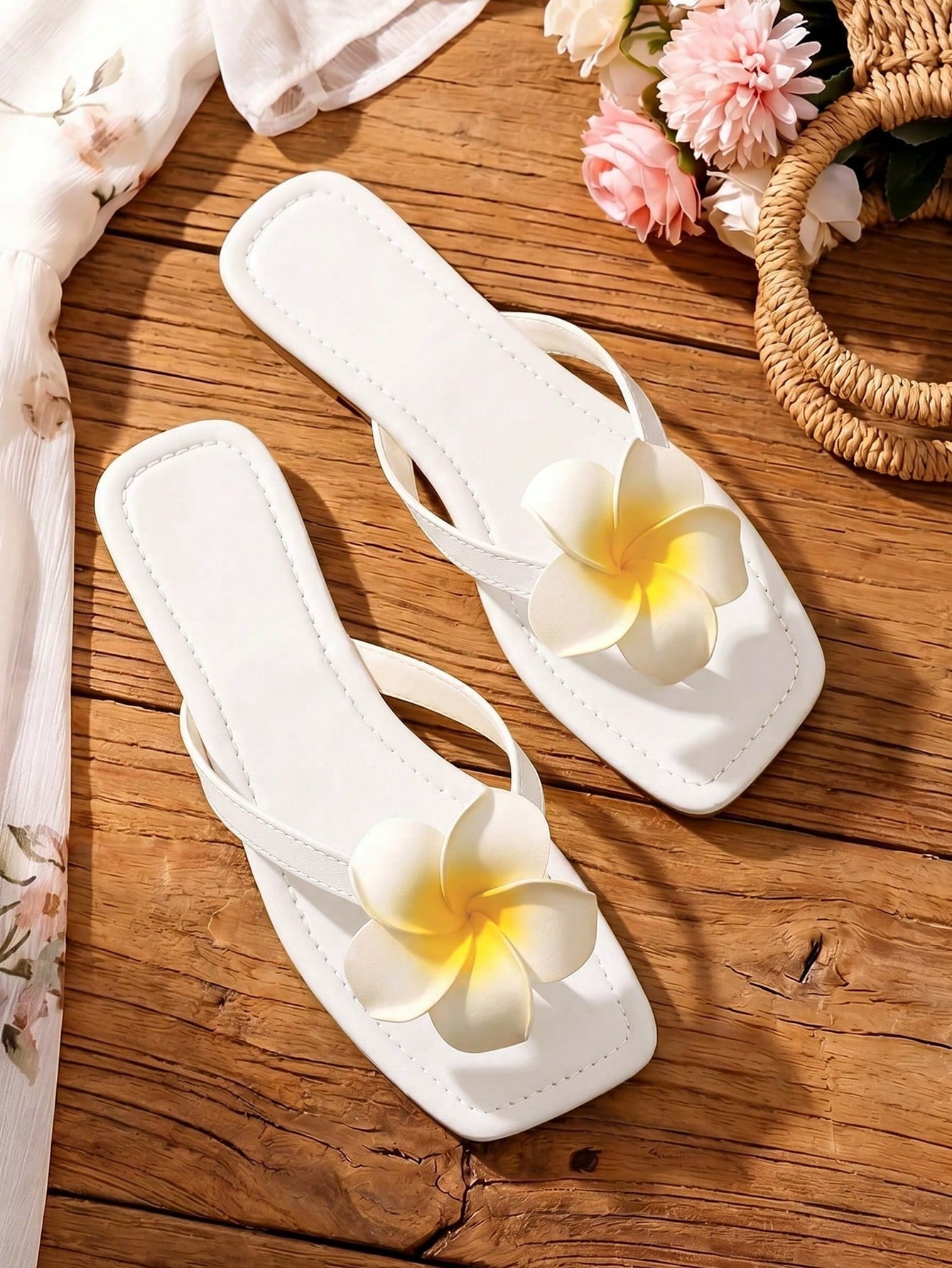 Women's black flat slide sandals with toe post design, textured PU leather straps, and rhinestone heart decoration.