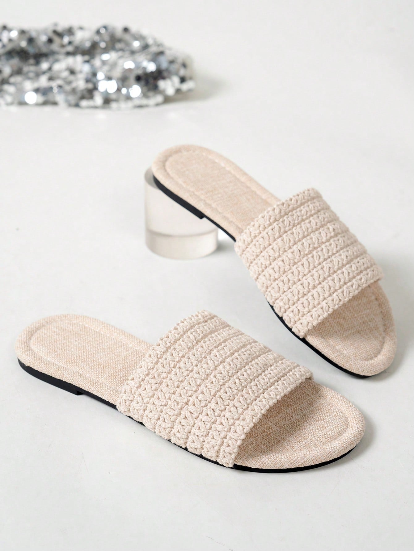 Women’s flat slide sandals featuring a floral printed strap and open toe design in a minimal style.