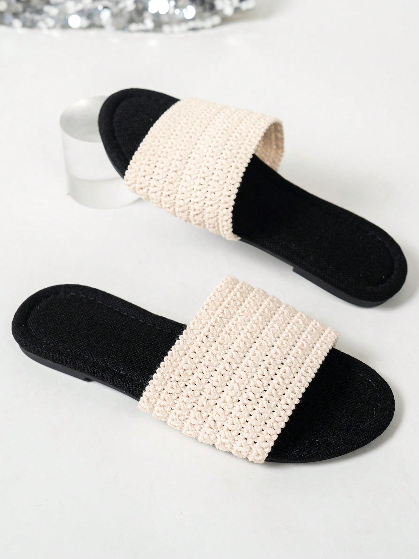 Women’s flat slide sandals featuring a floral printed strap and open toe design in a minimal style.