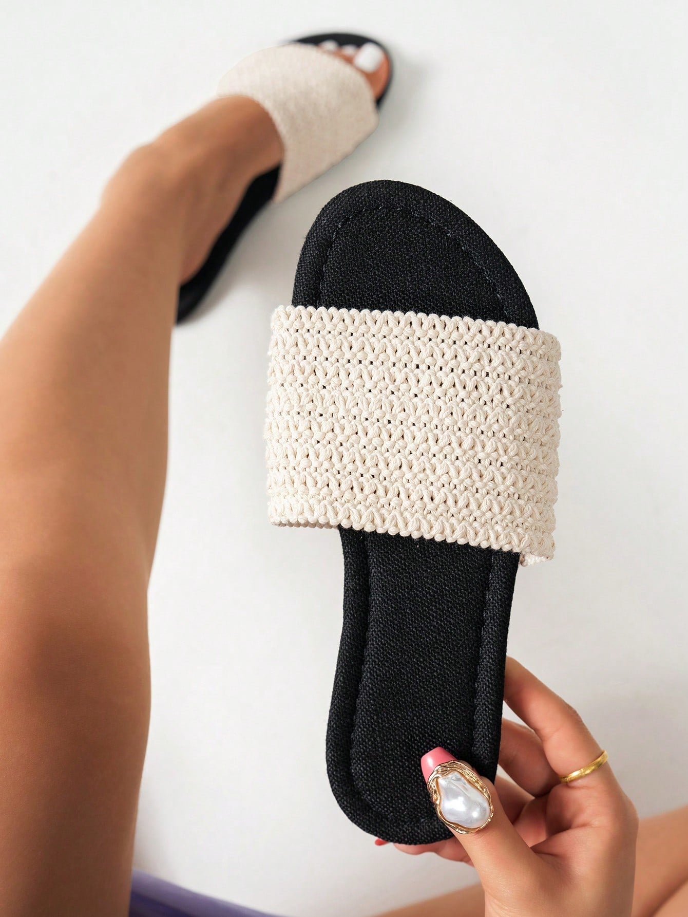 Women’s flat slide sandals featuring a floral printed strap and open toe design in a minimal style.