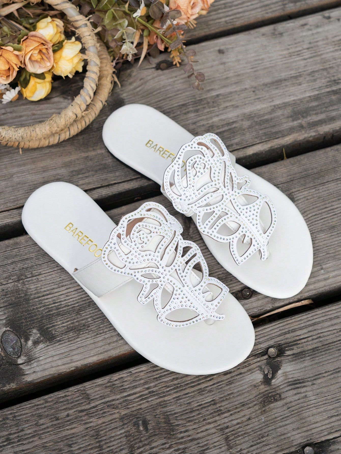 Women's flat sandals with strappy rope-detail design, plant pattern, and open-toe silhouette.