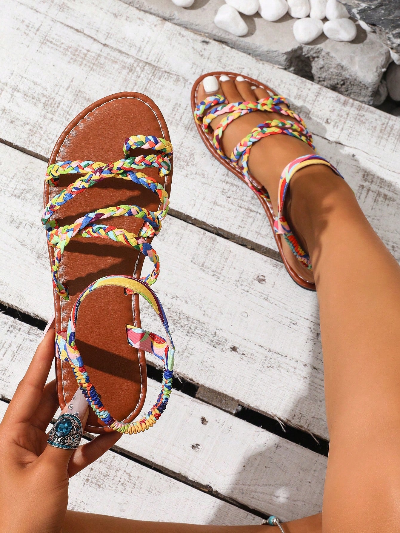 Women's flat sandals featuring a solid-color design with criss-cross braided straps and a toe-post slide style, suitable for beach, vacation, and casual wear.