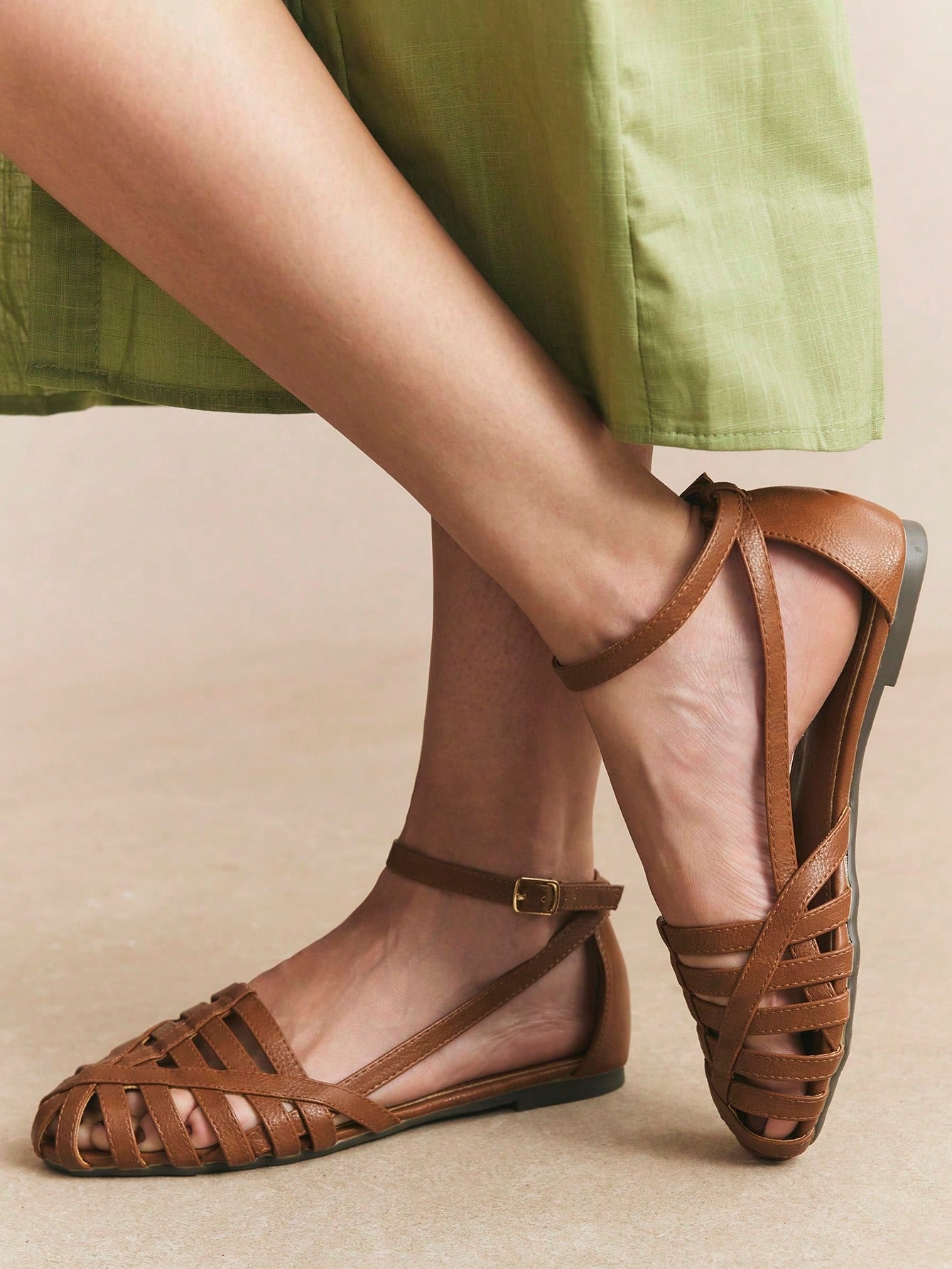 Women's flat gladiator sandals featuring a hollow-out multi-strap woven design and ankle strap style, with striped pattern and casual beach vacation look.