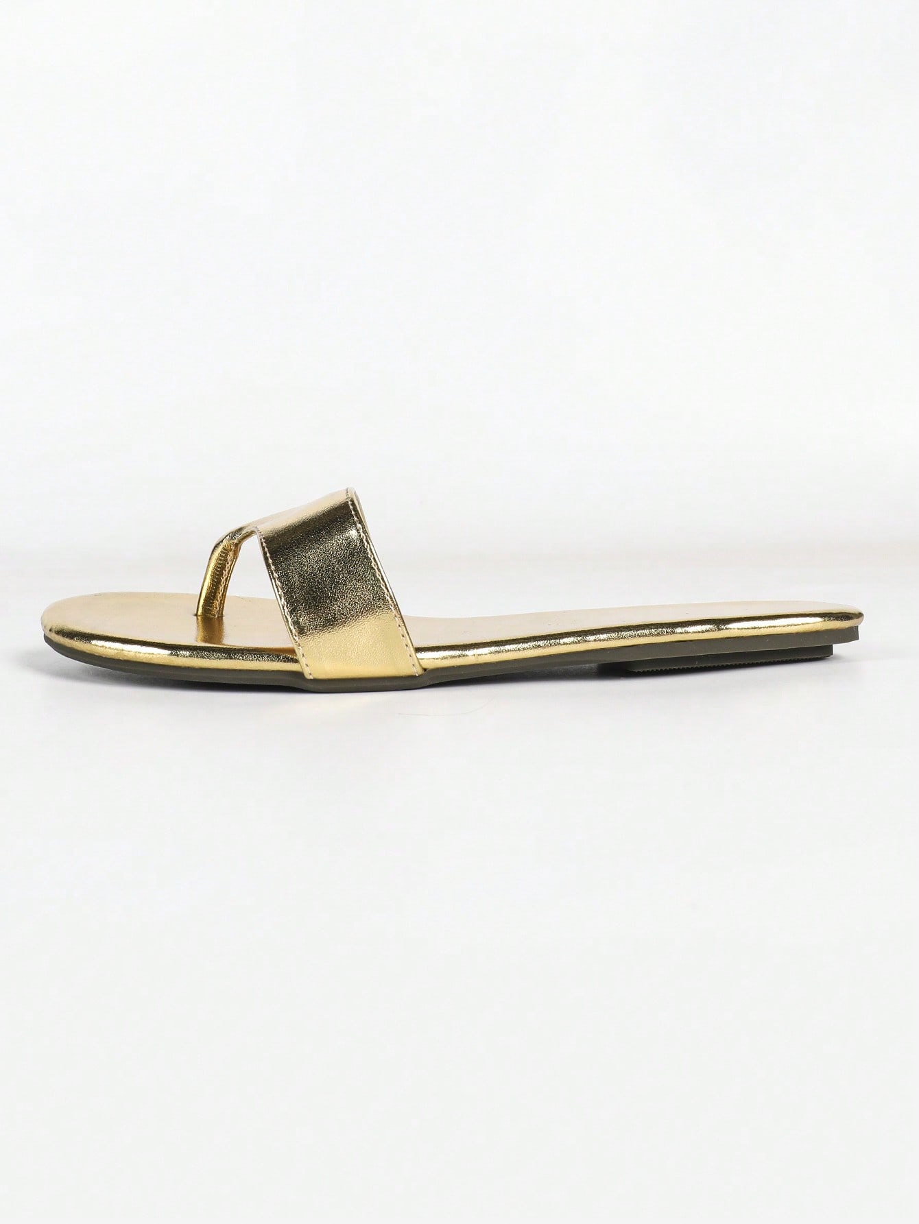 Women's gold flat sandals with metal accent detail, strappy lace-up design, and toe post thong style.