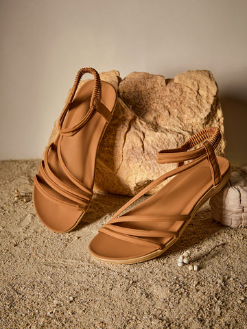 Brown women's strappy flat sandals with ruched details, animal pattern, and open-toe design.