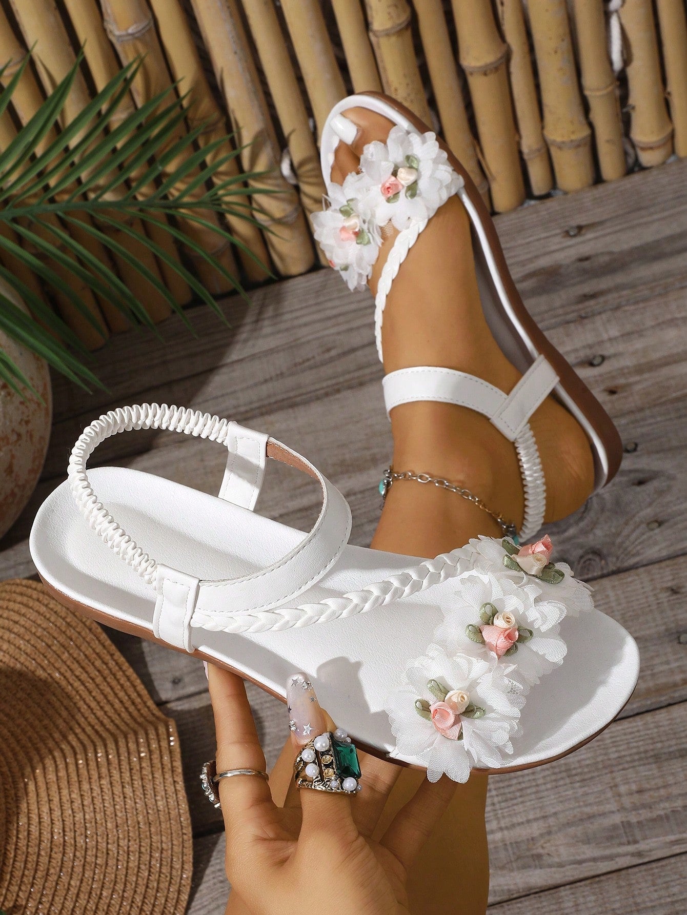 Women’s flat thong sandals featuring floral hollow-out details, open toe design, soft sole comfort, and elastic straps, suitable for beach, travel, party, wedding, and dress outfits.