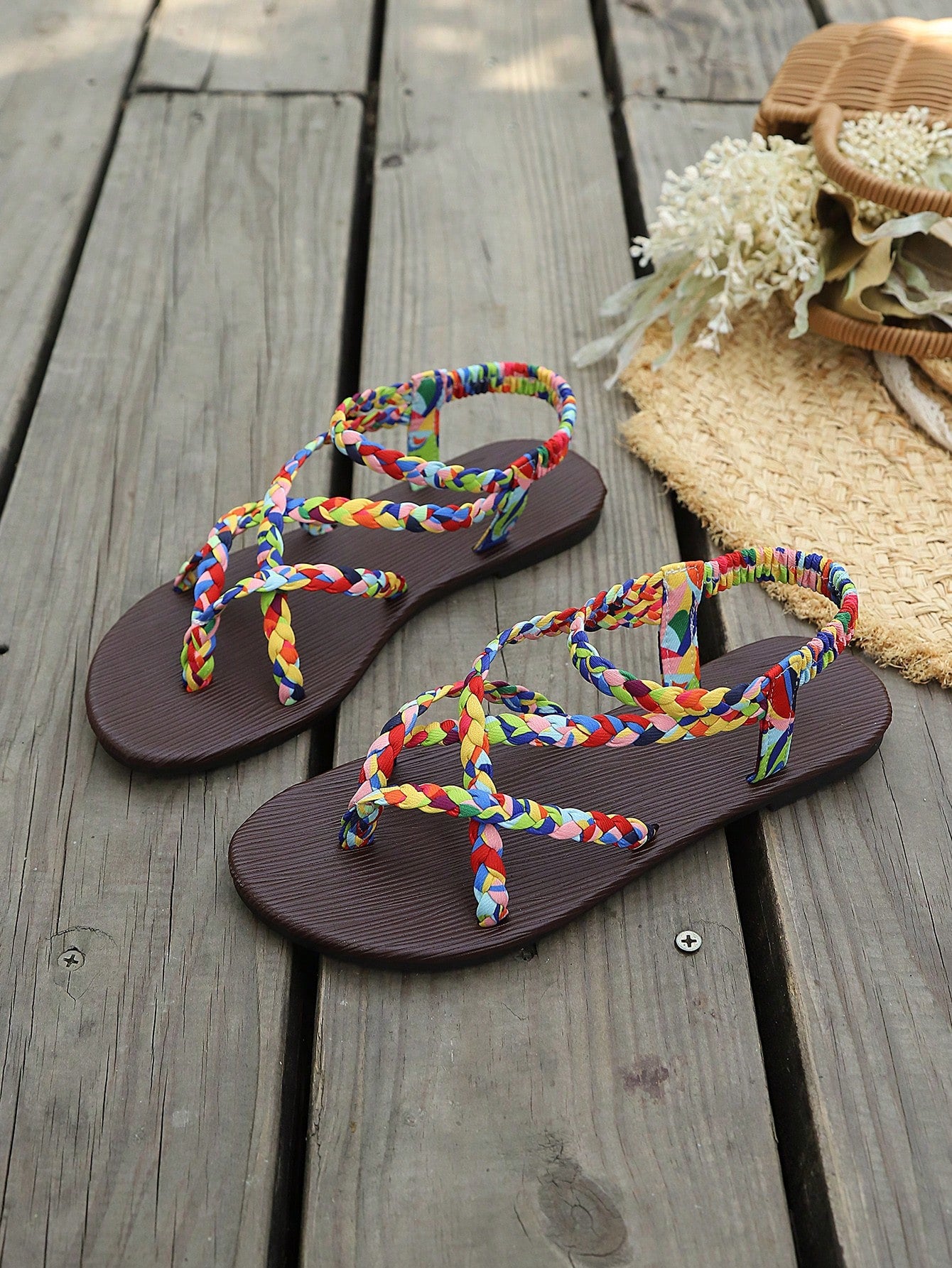 Open-toe flat slide sandals featuring rhinestone leaf decoration in a vacation-inspired style.