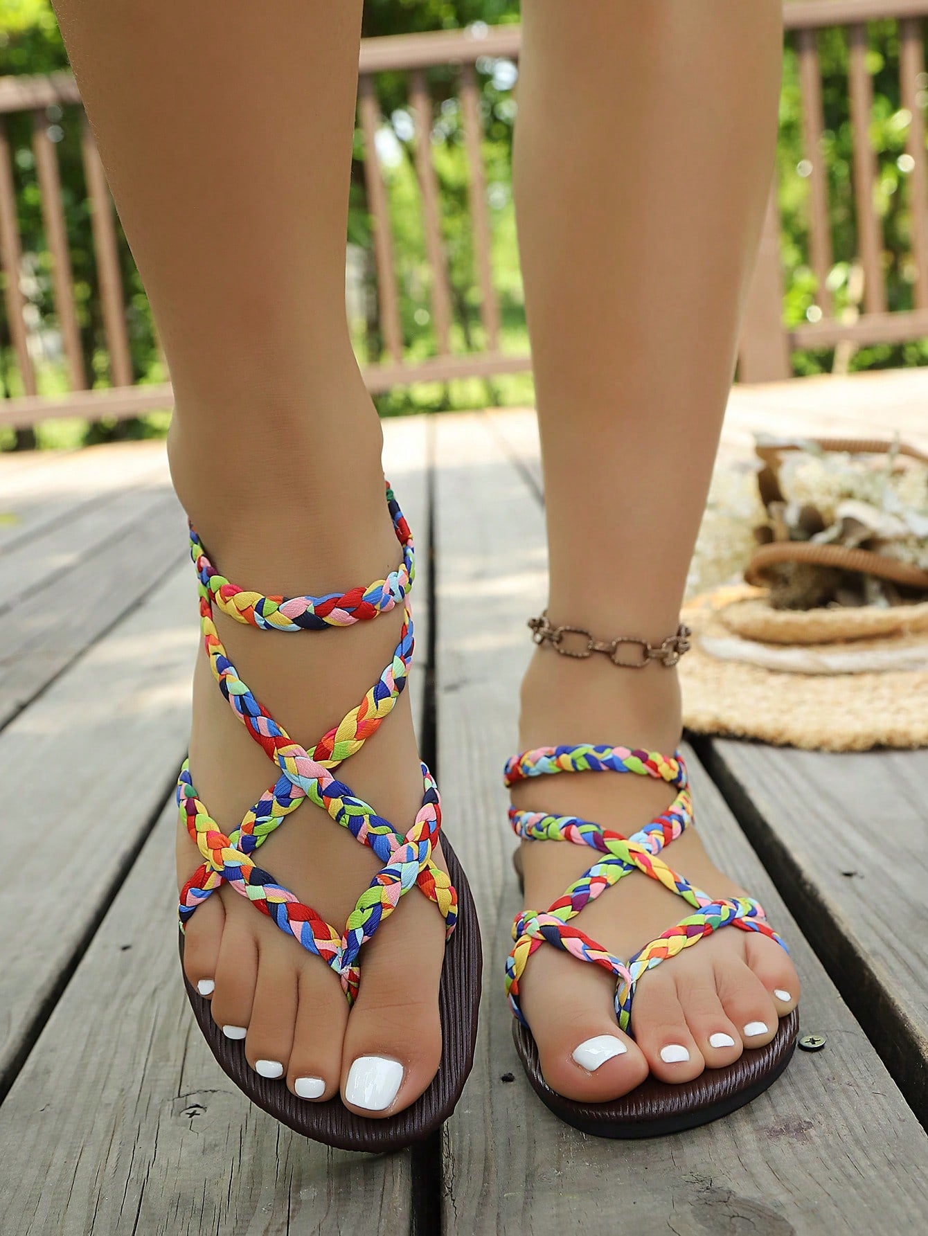 Open-toe flat slide sandals featuring rhinestone leaf decoration in a vacation-inspired style.
