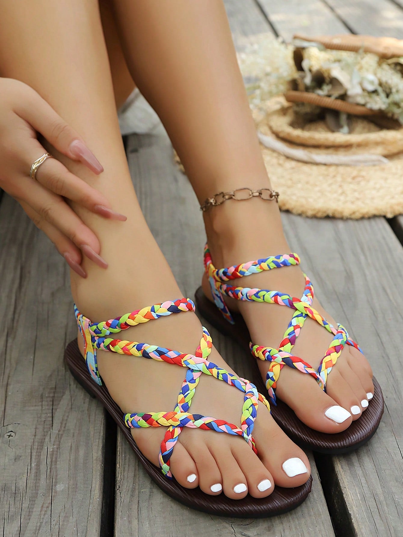 Open-toe flat slide sandals featuring rhinestone leaf decoration in a vacation-inspired style.