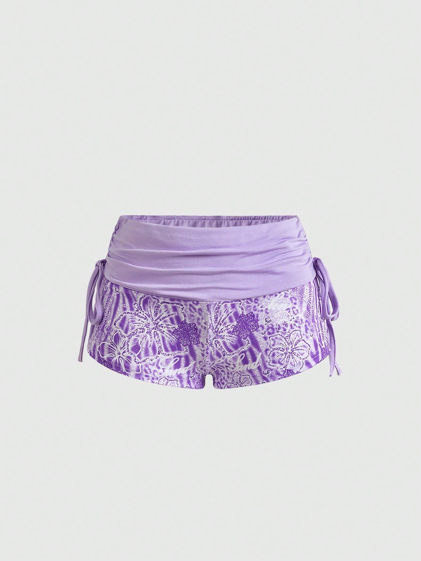 Women's low waist mini track shorts with elastic waistband, drawstring knot, ruched details, and plant pattern in a Y2K boho style