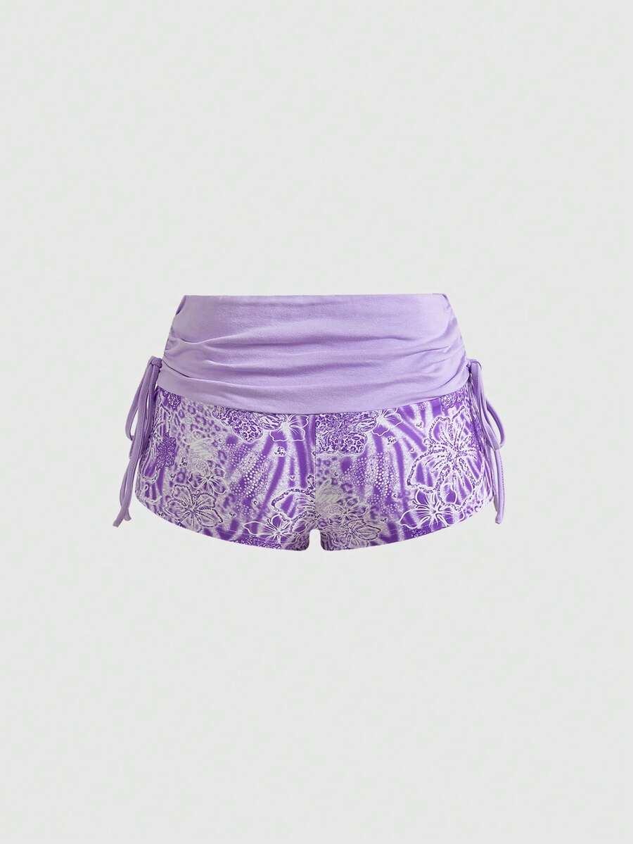 Women's low waist mini track shorts with elastic waistband, drawstring knot, ruched details, and plant pattern in a Y2K boho style