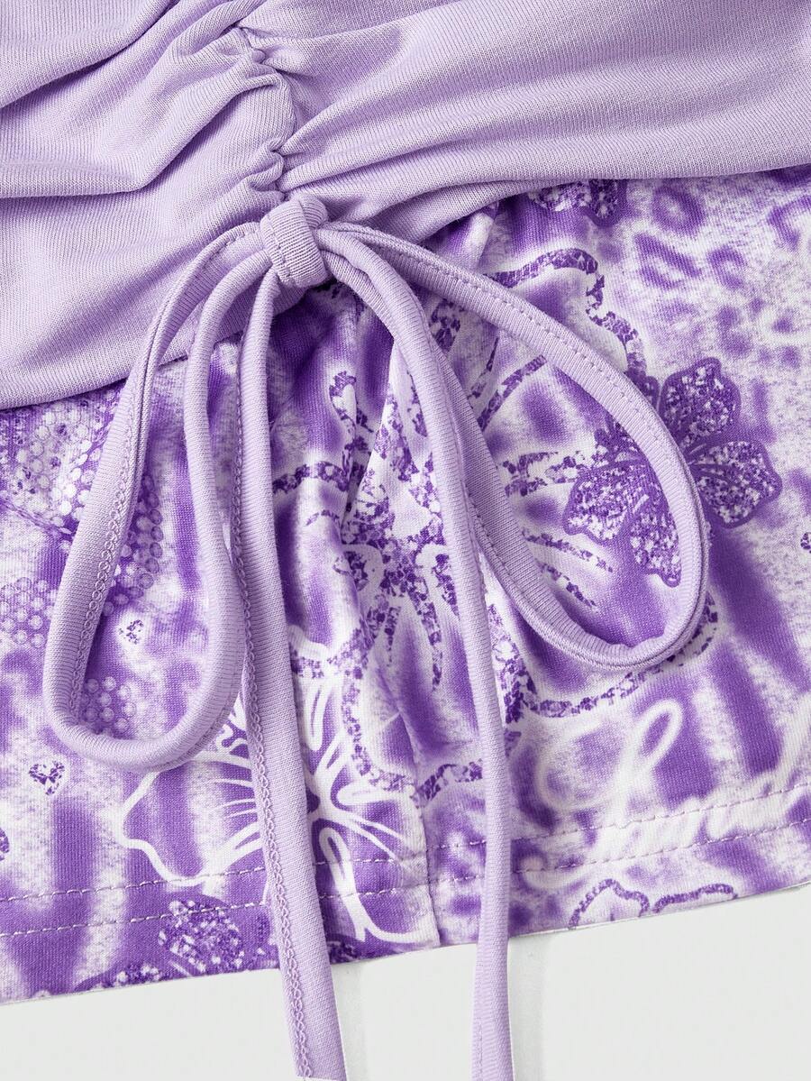 Women's low waist mini track shorts with elastic waistband, drawstring knot, ruched details, and plant pattern in a Y2K boho style