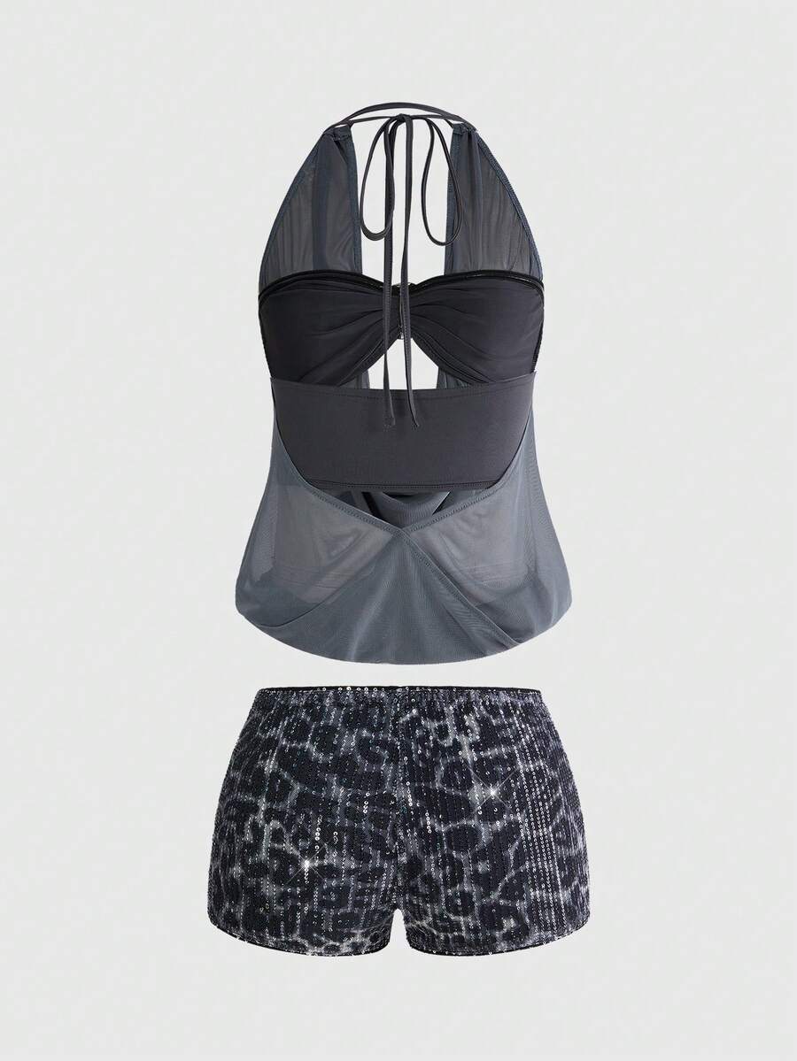 Women's two-piece outfit with a sleeveless halter cowl neck backless crop camisole, tie-back detail, bandeau inner, and leopard print shorts.