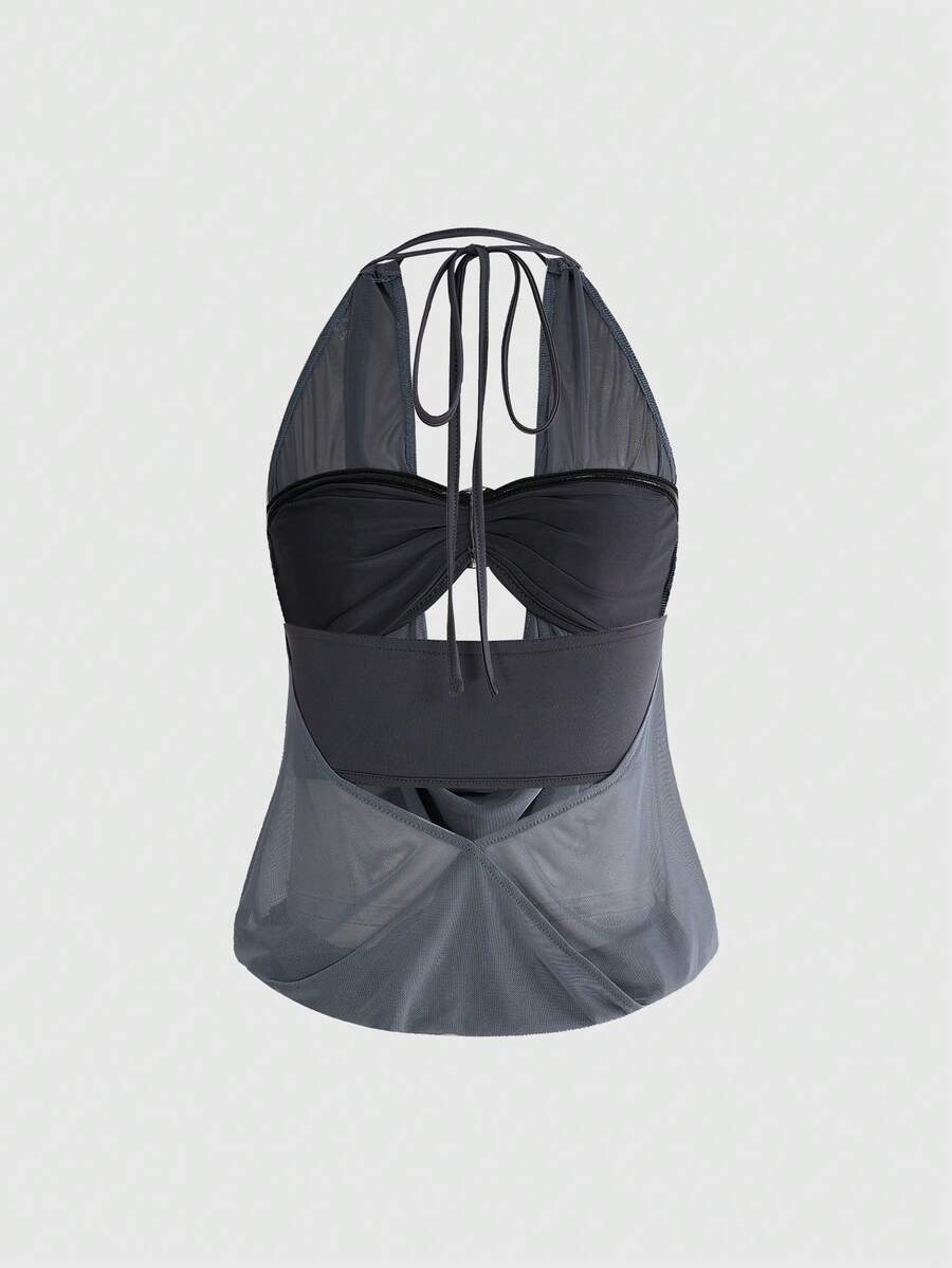 Women's two-piece outfit with a sleeveless halter cowl neck backless crop camisole, tie-back detail, bandeau inner, and leopard print shorts.