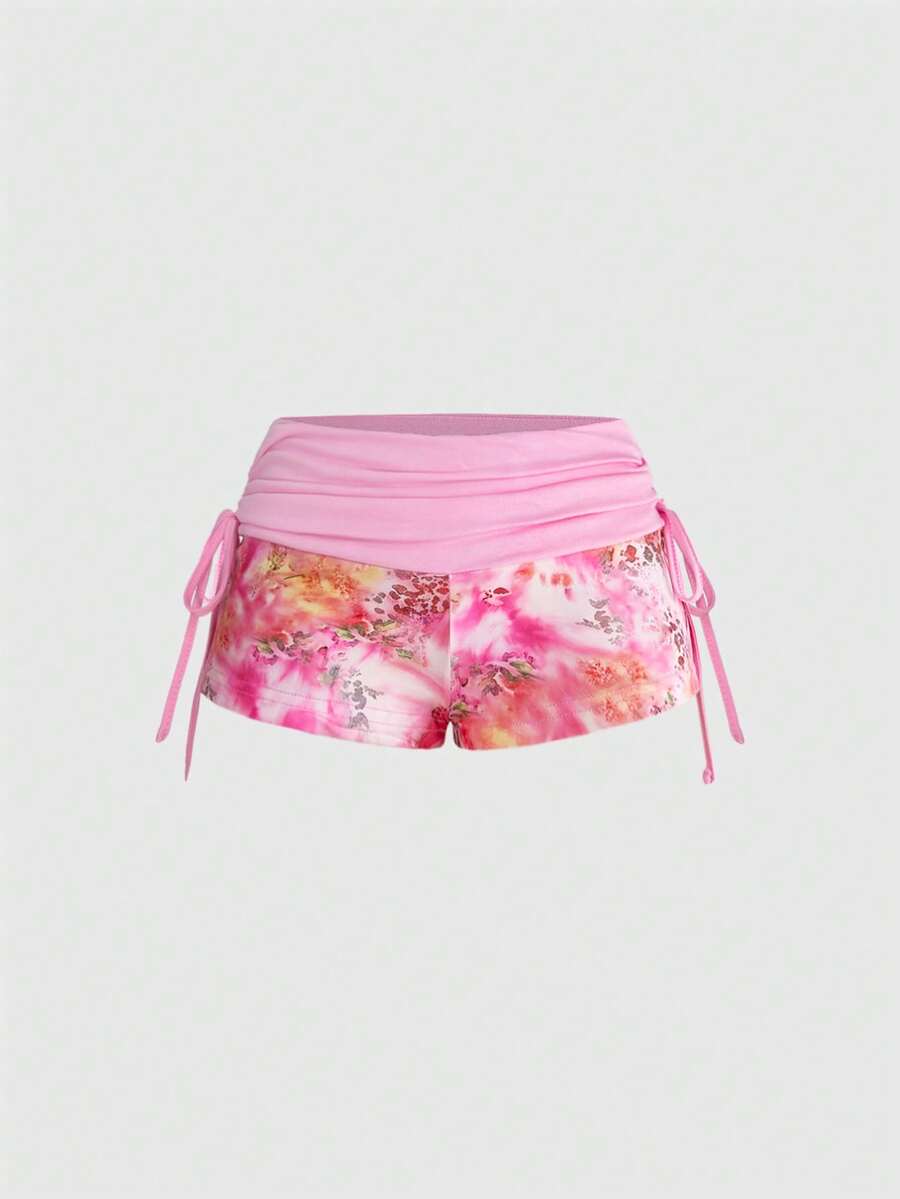 Women's low waist mini track shorts with elastic waistband, drawstring knot, ruched details, and plant pattern in a Y2K boho style