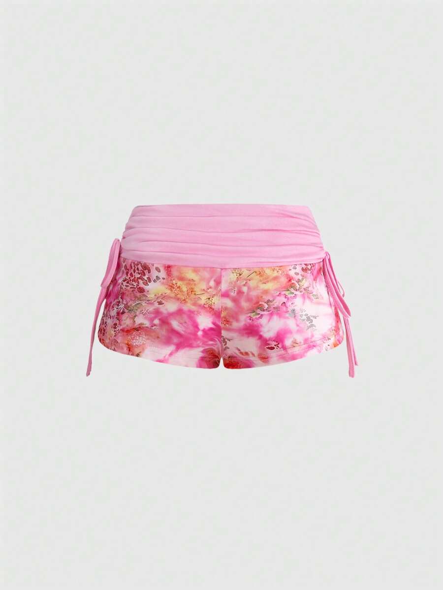 Women's low waist mini track shorts with elastic waistband, drawstring knot, ruched details, and plant pattern in a Y2K boho style