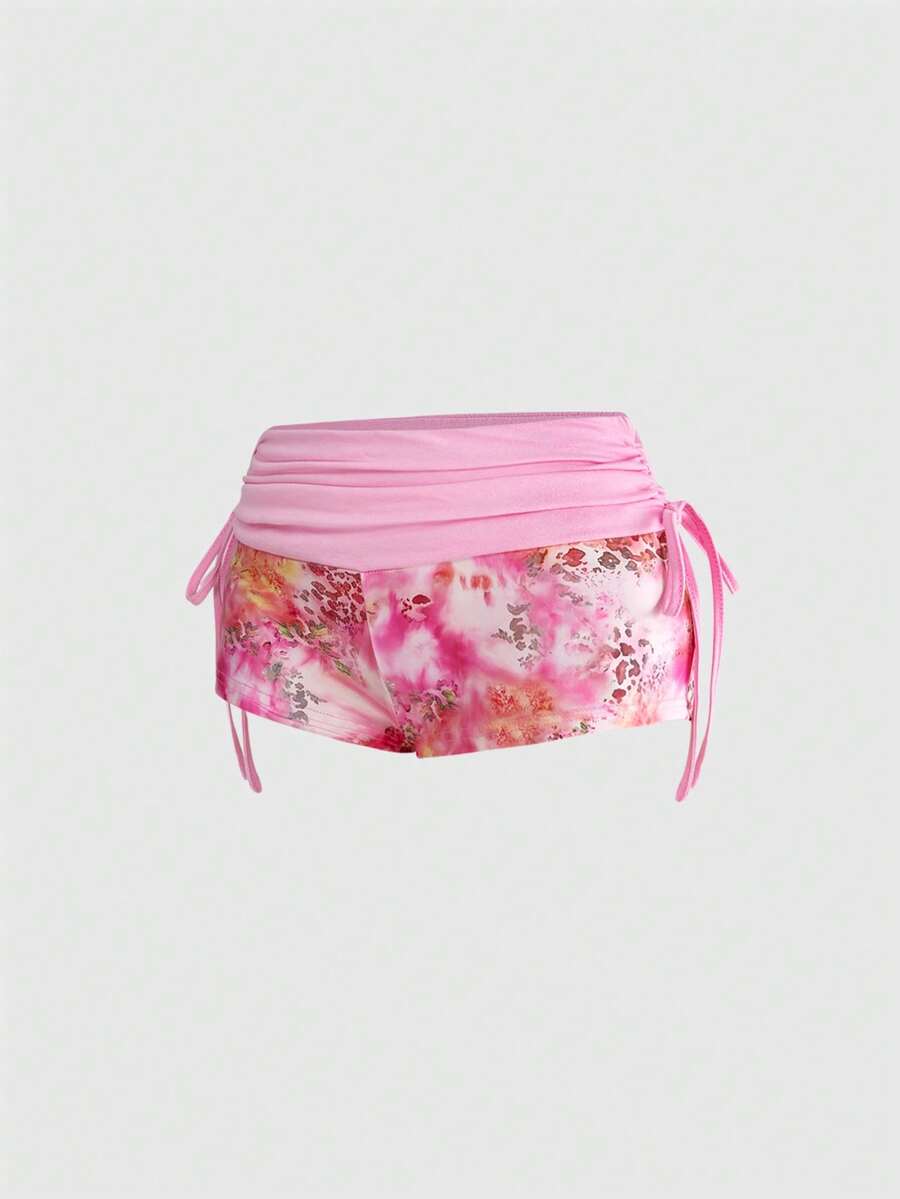 Women's low waist mini track shorts with elastic waistband, drawstring knot, ruched details, and plant pattern in a Y2K boho style