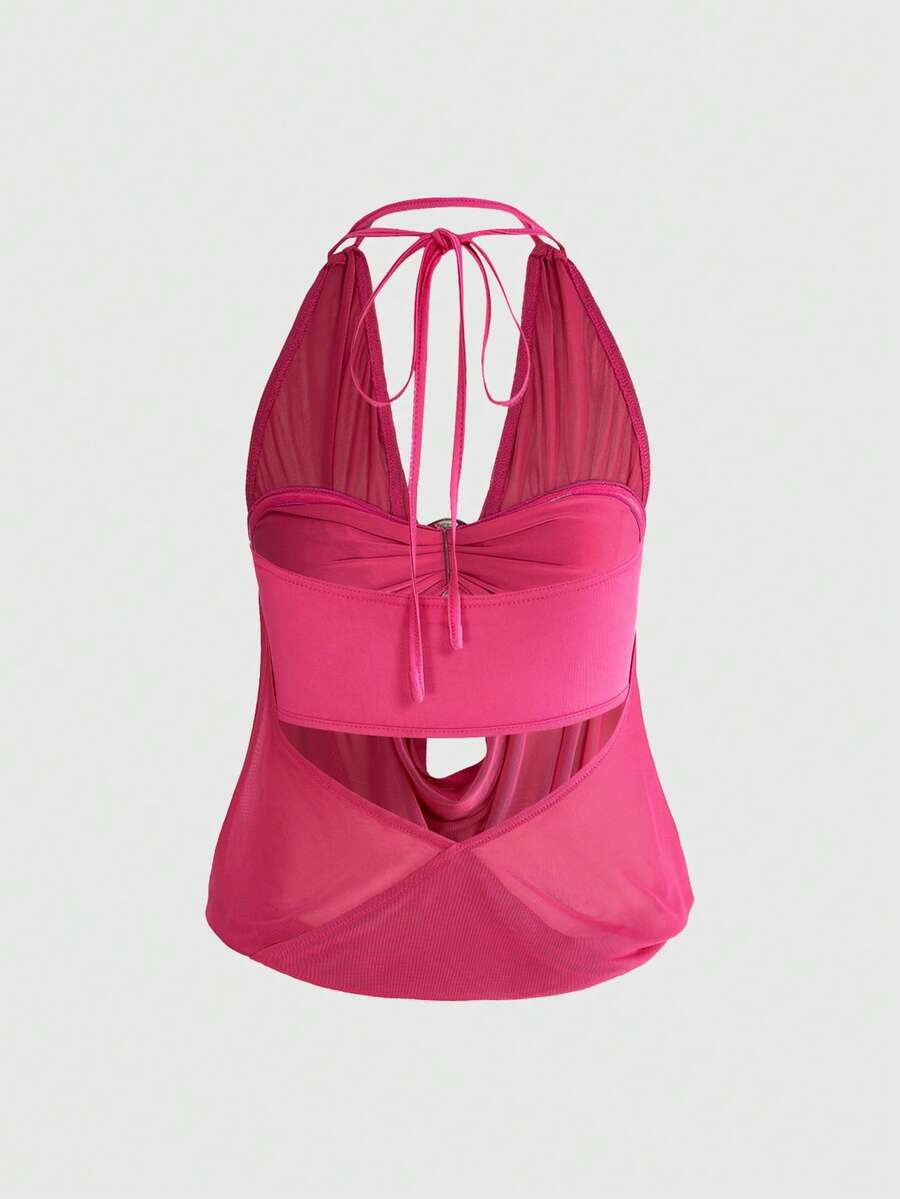 Women's two-piece outfit with a sleeveless halter cowl neck backless crop camisole, tie-back detail, bandeau inner, and leopard print shorts.