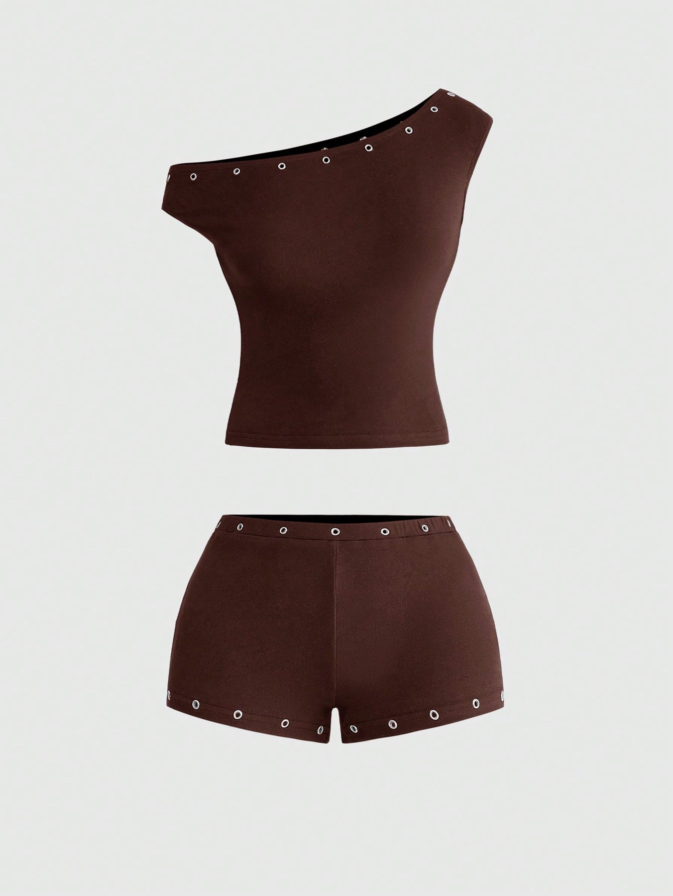Women's two-piece outfit with an asymmetric neck studded grommet crop top and super low-rise mini shorts
