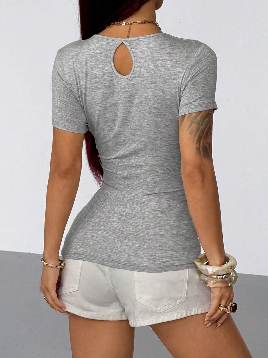 Women's slim fit short sleeve T-shirt with a low cut cowl neck, ruched details, and ruffle hem in a casual Y2K-inspired streetwear style.