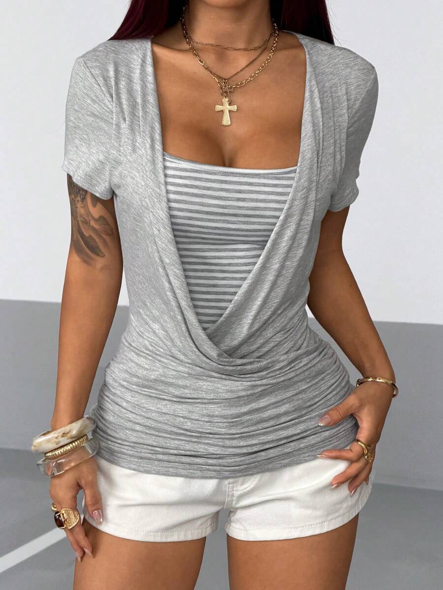 Women's slim fit short sleeve T-shirt with a low cut cowl neck, ruched details, and ruffle hem in a casual Y2K-inspired streetwear style.