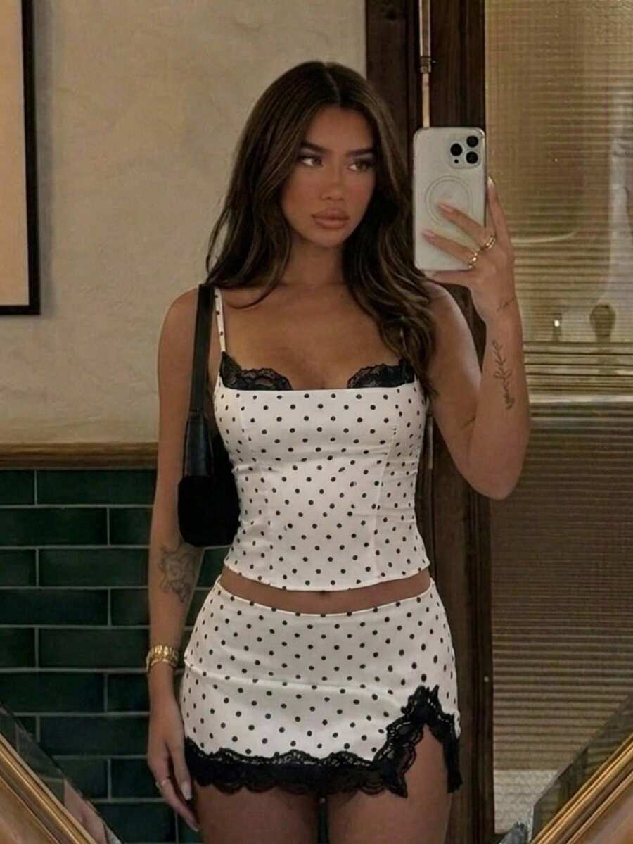 Women's black and white polka dot 2-piece set with contrast lace camisole, spaghetti straps, and matching side slit mini skirt