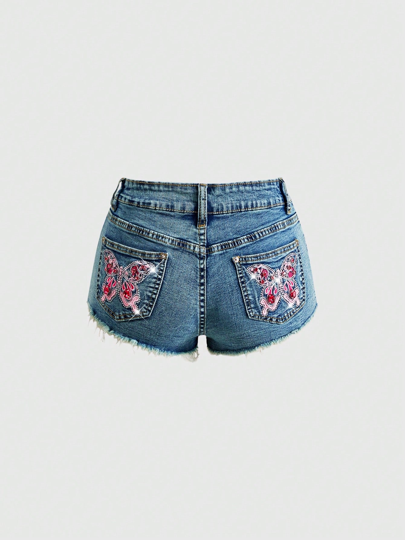 Women's medium wash low waist shorts with butterfly embroidery, rhinestone embellishments, zipper fly, and skinny fit
