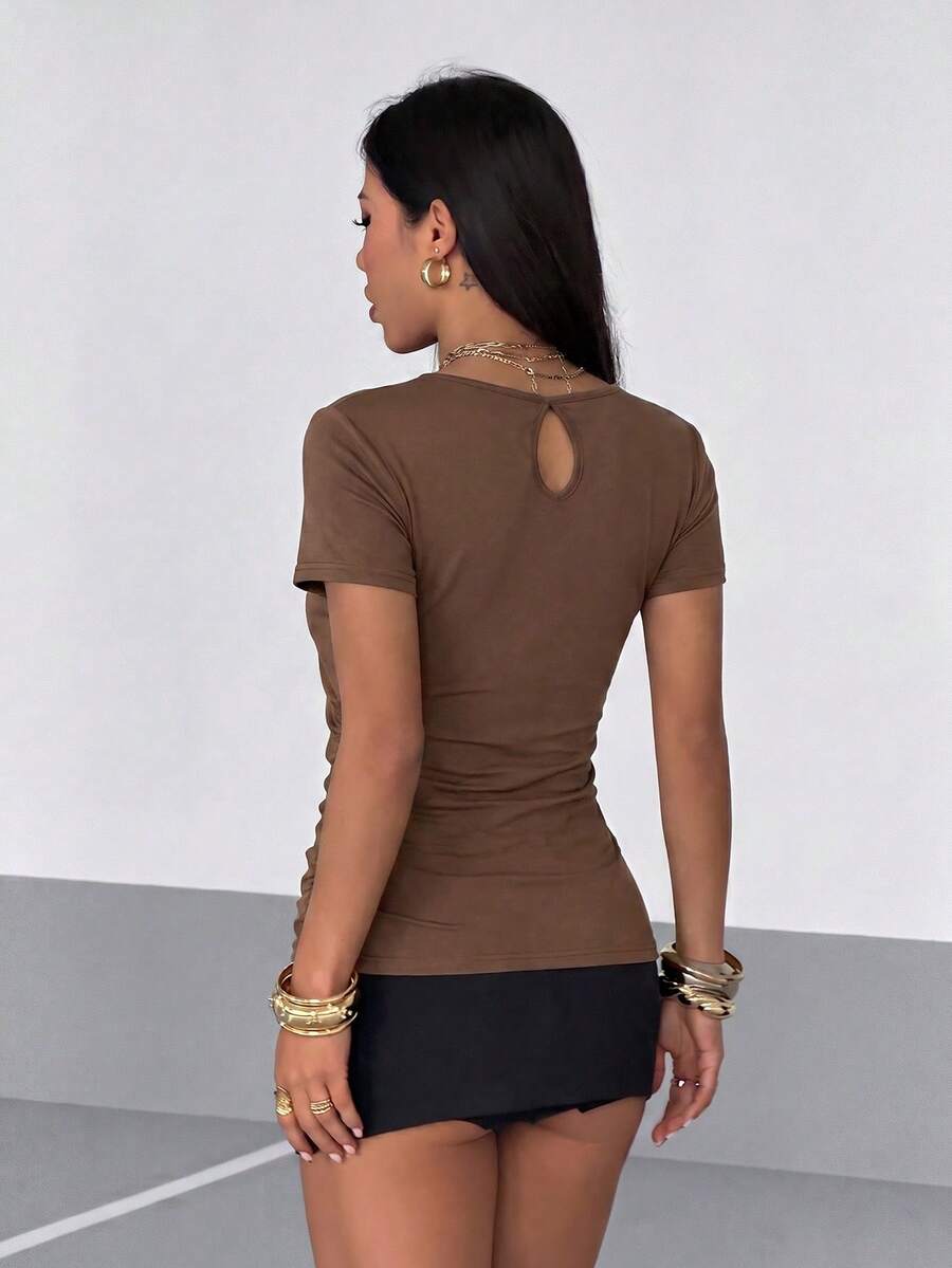 Women's slim fit short sleeve T-shirt with a low cut cowl neck, ruched details, and ruffle hem in a casual Y2K-inspired streetwear style.