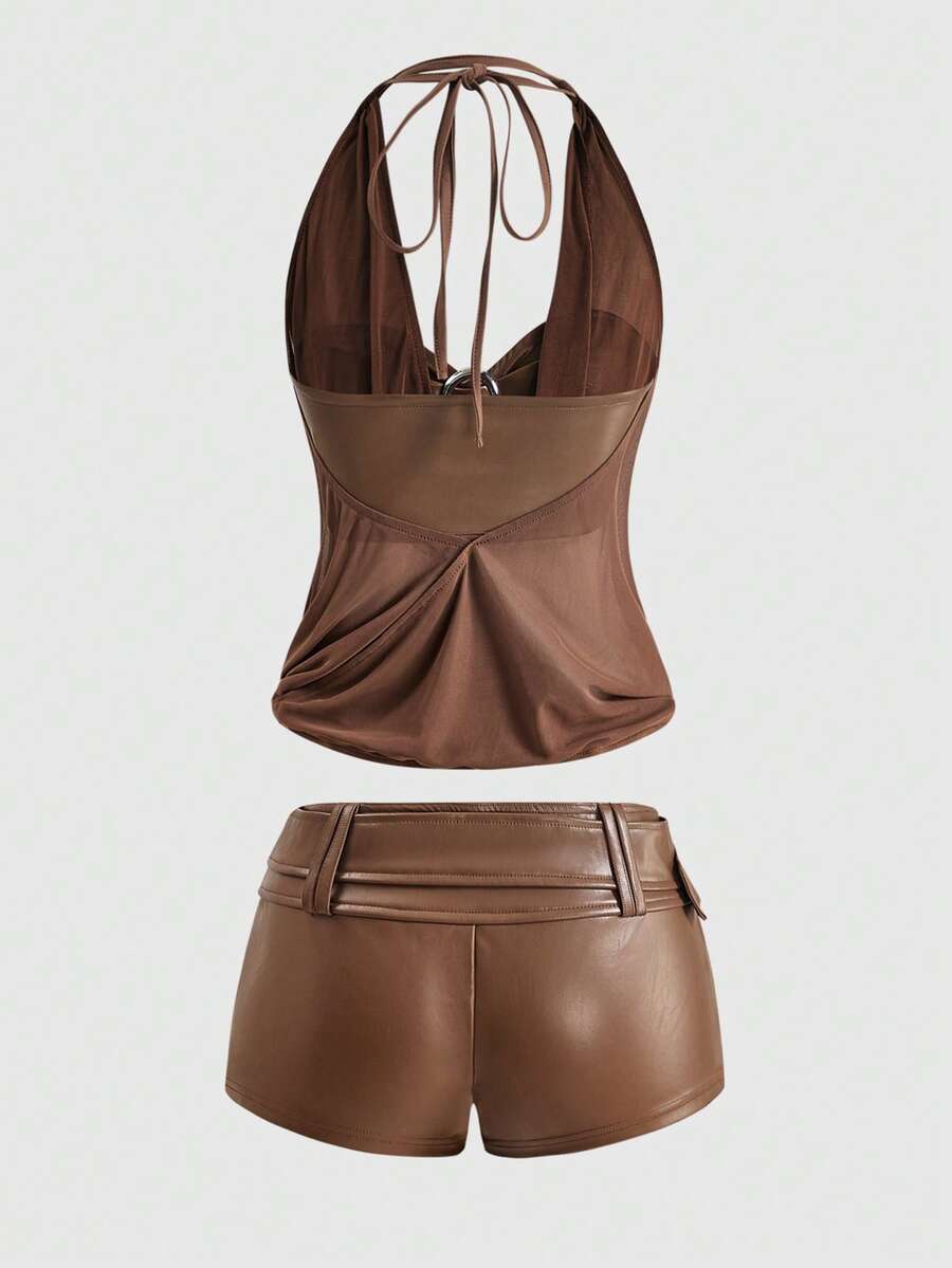 Women's Gyaru-style two-piece outfit with a draped halter crop top, backless tie detail, and mini bodycon shorts