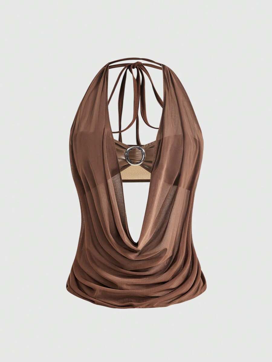 Women's Gyaru-style two-piece outfit with a draped halter crop top, backless tie detail, and mini bodycon shorts