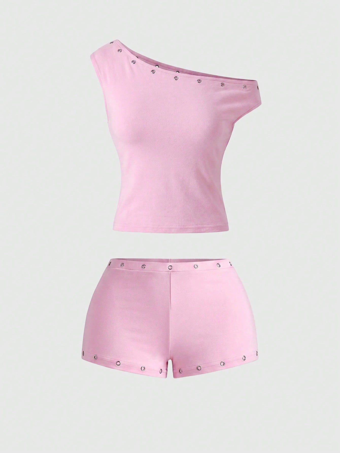 Women's two-piece outfit with an asymmetric neck studded grommet crop top and super low-rise mini shorts