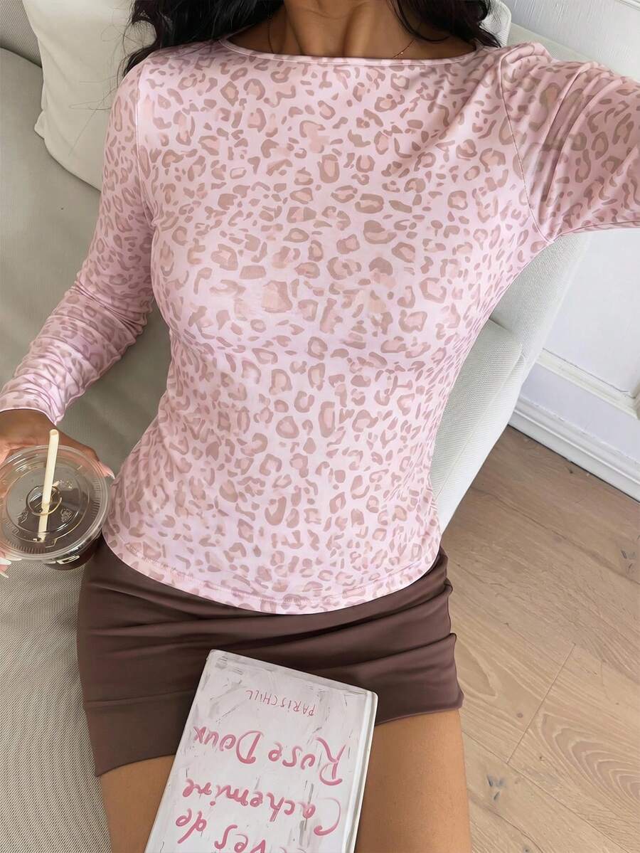 Casual CovetEZ long sleeve T-shirt with leopard-style random print, round neck, loose fit, and asymmetrical detail