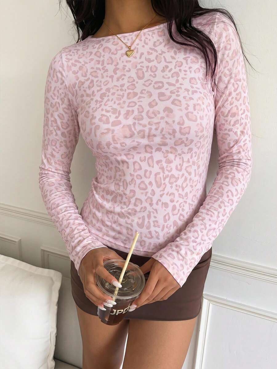 Casual CovetEZ long sleeve T-shirt with leopard-style random print, round neck, loose fit, and asymmetrical detail