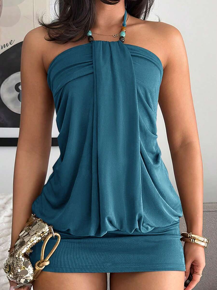 Women's coffee mini dress with halter neckline, backless draped design, sleeveless slim fit silhouette, straight hem, and high-stretch knitted fabric.