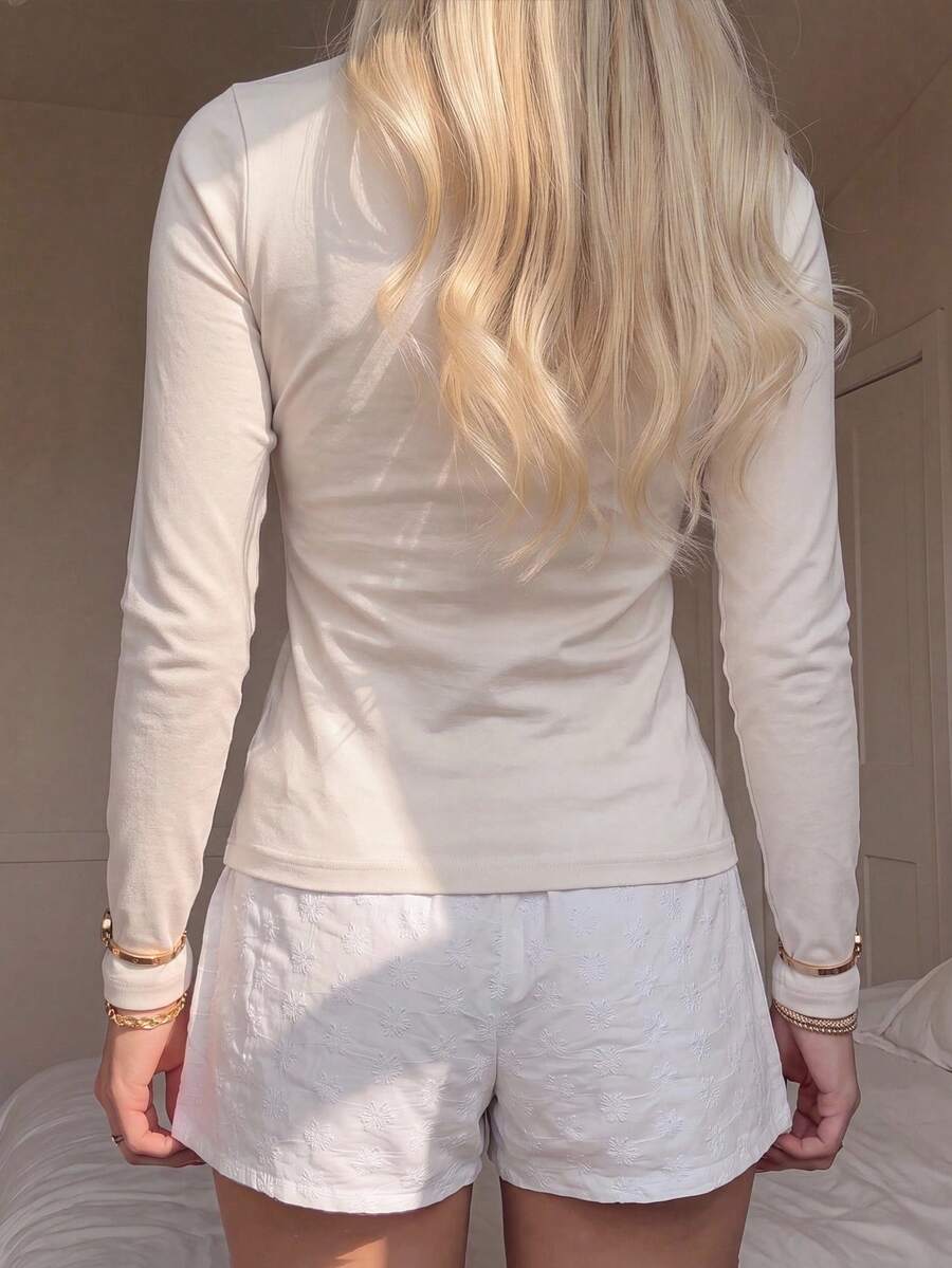 Casual CovetEZ long sleeve T-shirt with leopard-style random print, round neck, loose fit, and asymmetrical detail